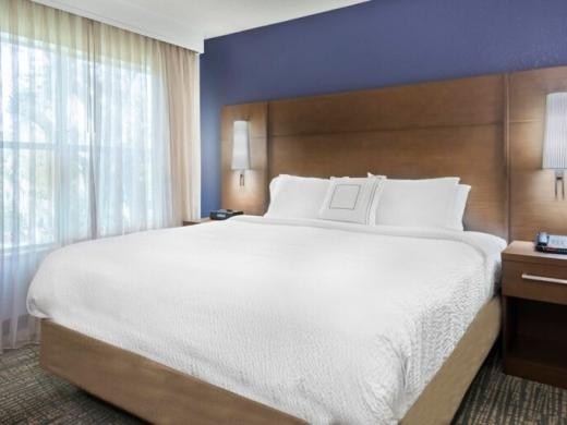 One Bedroom Queen Suite - Enjoy a comfortable night's rest in our plush bedding in every suite. Photo 11