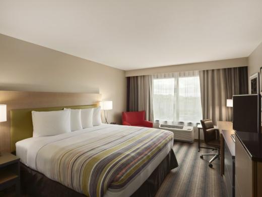 1 King Bed - 1 King Size bed with Serta Perfect Sleeper Mattresses and 43" HDTV microwave, refrigerator, coffee maker, free Wi-Fi and complimentary hot & cold breakfast buffet. Photo 5