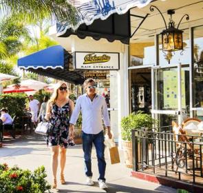 Couple walking by shops in St. Armonds Circle