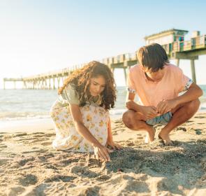 Kids looking for shells and shark teeth at Venice Pier