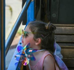 little girl looking out trolley window