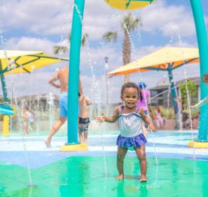 little girl cooling off at a splash pad in sarasota