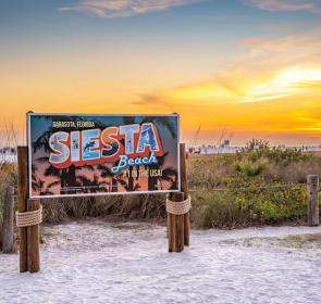 sign on siesta key beach at sunset