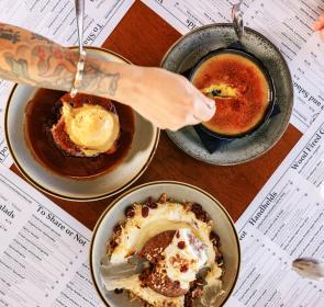 A hand dips into a bowl at 1592 in downtown Sarasota