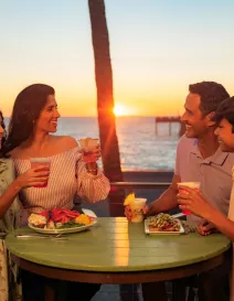 family dining at sunset at fins overlooking venice fishing pier