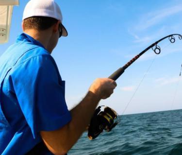 Man fishing off boat in the Gulf