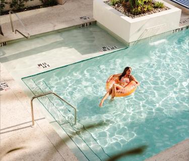 emma weyant floating in pool at hotel