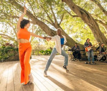 Couple dances under the trees at Selby Gardens