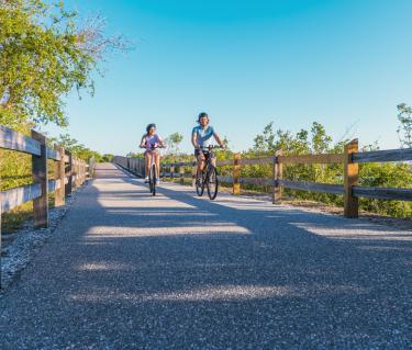 couple biking down the legacy trail