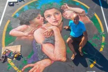 Man siting on Chalk Drawing in a parking space