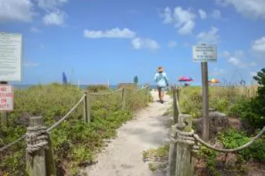 Person walking on a path to Turtle Beach 