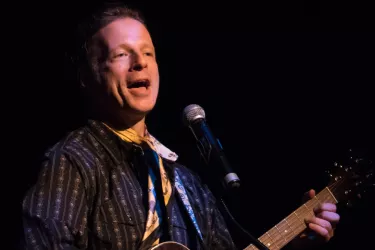 Cast Member, Joe Casey, sings and plays the guitar.