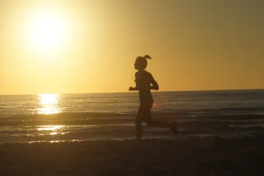 Running on the on Siesta Beach at Dusk can be a beautiful way to burn calories