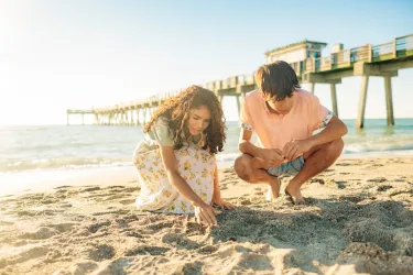 Kids looking for shells and shark teeth at Venice Pier