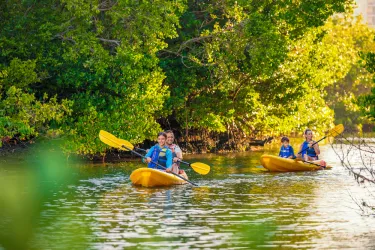 family kayaking at the bay park