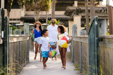family walking to beach from ritz carlton sarasota