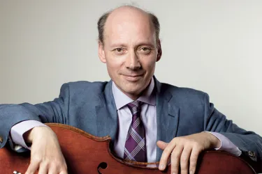 Cellist posing with his cello