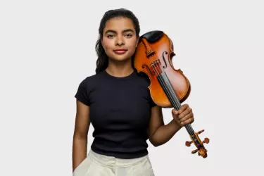 Violinist Amaryn Olmeda poses with a violin on her left-shoulder