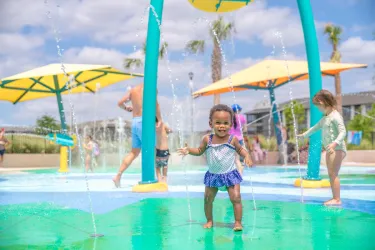 little girl cooling off at a splash pad in sarasota