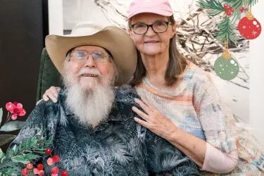 Clyde and Niki Butcher with Christmas graphic