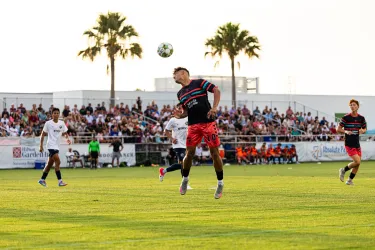 Paradise player heading a ball