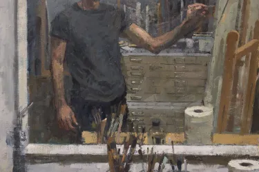 Portrait of a man painting on a canvas 