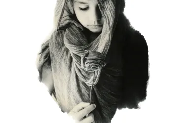 Black and white image of a young, solemn-looking boy with dark hair. His head is covered in a textured middle-eastern style scarf and he's looking down at a rose he's holding.