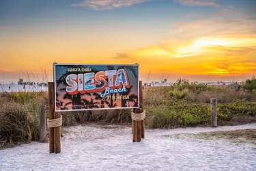 sign on siesta key beach at sunset