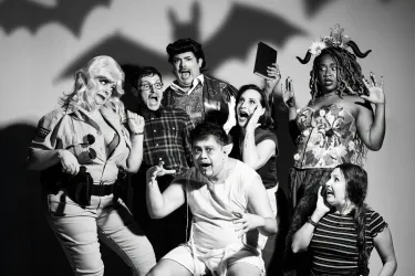 A black and white photo of some of the cast of bat boy in a horror movie style