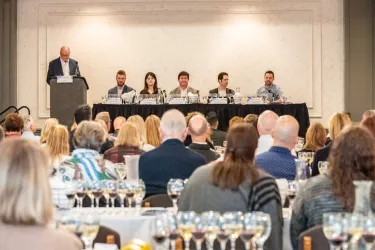 Guests sip and savor wine while listening to a panel of winemakers