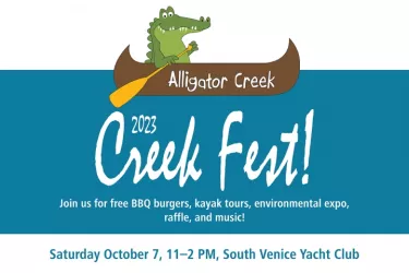 cartoon alligator paddling canoe above text "Alligator Creek Fest" Photo