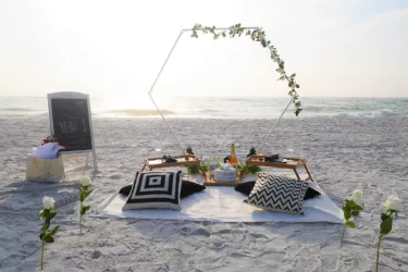 Romantic Picnic - Sunset beach picnic ideal for celebrations, relaxing or simply because. This picnic features our white hexagon backdrop, beautifully framing the scenery. Photo