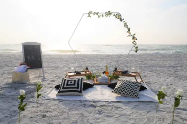 Romantic Picnic - Sunset beach picnic ideal for celebrations, relaxing or simply because. This picnic features our white hexagon backdrop, beautifully framing the scenery. Photo